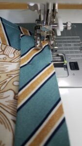 Binding being sewn onto a placemat.